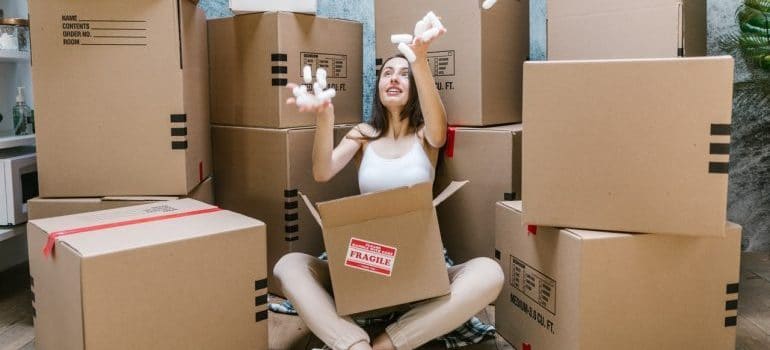 A girl playing with packing supplies